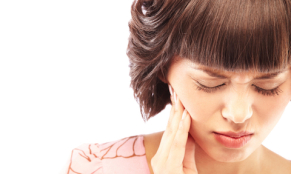 Close-up of a woman having toothache isolated on white background